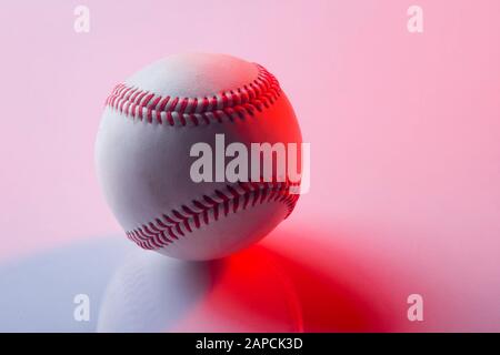 Baseball ball isolated on pinkbackground. Red neon Banner Art concept Stock Photo