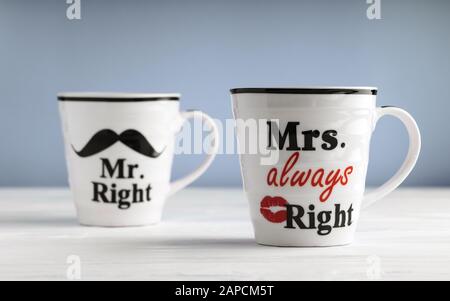 Two mugs with printed text Mr. right and Mrs. always right. Funny phrase about couples life printed on mug Stock Photo