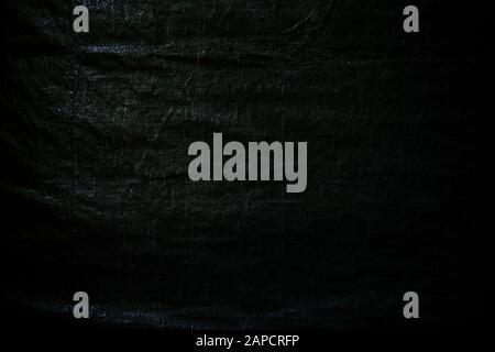 Wrinkled green tarp. Dark high resolution abstract full frame textured background. Stock Photo