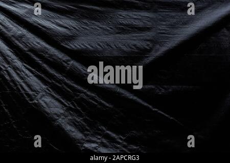 Wrinkled gray tarp. Dark high resolution abstract full frame textured background. Stock Photo