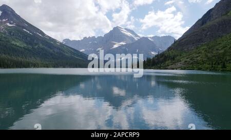 reflections on lake josephine in glacier national park Stock Photo