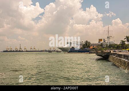 View of cranes boats and cruises in the port of Georgetown on Penang Island, over the Strait of Malacca. Malaysia Stock Photo