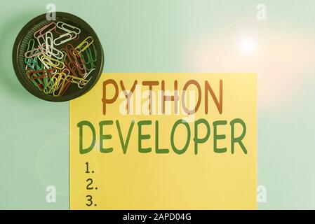 Handwriting text writing Python Developer. Conceptual photo responsible for writing serverside web application logic Plain cardboard and writing equip Stock Photo