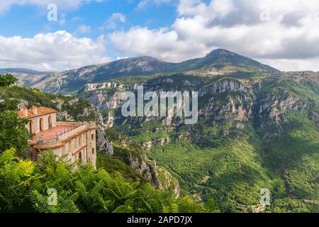 A medieval mountaintop castle overlooks a valley in the Alpes-Maritimes area of Southern France, near the village of Gourdon Stock Photo