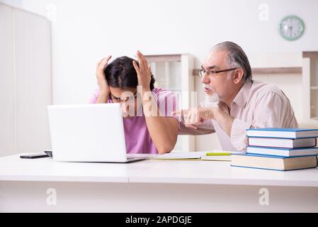 The old father helping his son in exam preparation Stock Photo