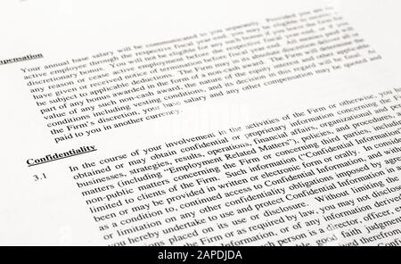 Text of Confidentiality clause of a generic corporate employment agreement. Shallow depth of field. Stock Photo