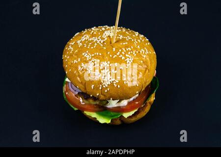 Fresh tasty burger on black background front views Stock Photo