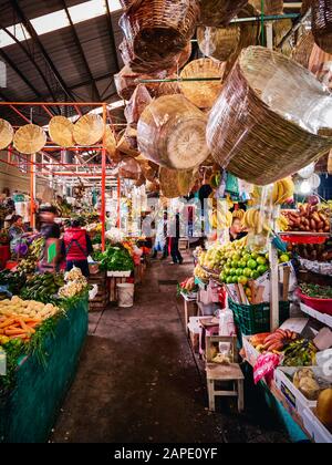 San Pedro Cholula, Mexico, October 17, 2018 - Colorful view of fruit and vegetable stalls with vendors in Mexican Market of San Pedro Cholula Stock Photo