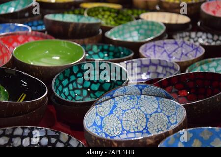 Multicolored Bowls for sale at the local market in Thailand Stock Photo