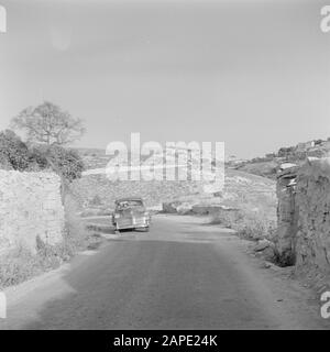 Israel 1948-1949: Canaan (Canaan) Description: Car on a mountain road with on the horizon a Tegart fort Annotation: Tegart forts (also called Taggart forts) are fortified concrete police stations that were built in strategic locations throughout Palestine in 1938, when this was a British mandate area. They are named after British policeman and engineer Sir Charles Tegart Date: 1948 Location: Israel, Safad Keywords: cars, mountains, police stations, defenses, roads Stock Photo