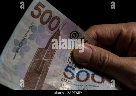 Closeup shot of 500 Hong Kong dollars (HKD) banknotes in front of a black background Stock Photo