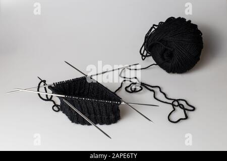 High angle shot of knitting materials with black thread