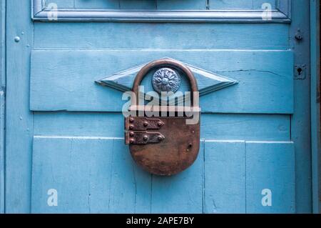 Mailbox in the shape of a large padlock, hanging on a blue door in Dinan, France. Stock Photo