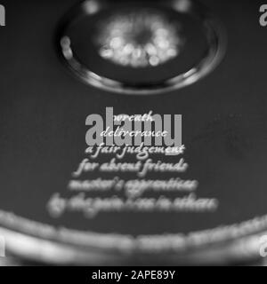 Closeup shot of several words written on a circular black surface Stock Photo