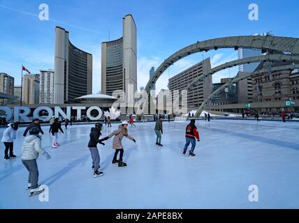 TORONTO - JANUARY 2020:  The skating rink in Civic Square in front of City Hall is a popular winter attraction. Stock Photo