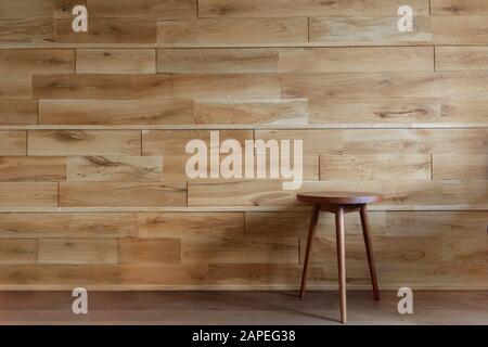 Round chair beside wooden wall Stock Photo