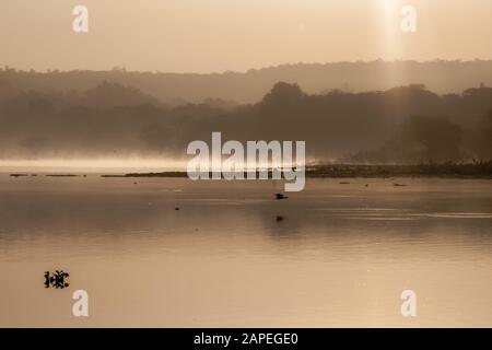 Sunrise over the lake with reflection mist on the water, Landscape sunrise concept Stock Photo
