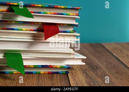 A stack of different bookmarks with bookmarks for pages. Book binding. Knowledge and education. Books for children. School library. Stock Photo