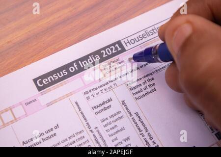 Maski, India 18,January 2020 - Close up of hands filling up the Census of India 2021 Form or NPR at house for population register at india. Stock Photo