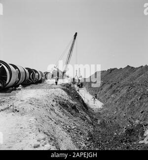 irrigation project in the Negev Desert. A moving crane lays pipes in an ...