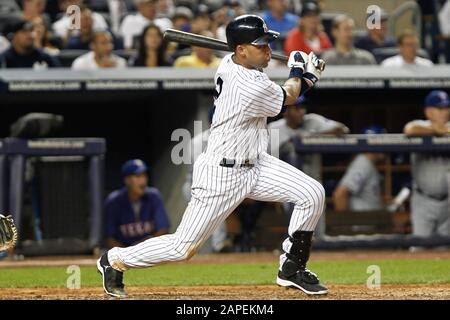 BRONX, NY - AUG 14: New York Yankees shortstop Derek Jeter (2) singles to center against the Texas Rangers on August 14, 2012 at Yankee Stadium. Stock Photo