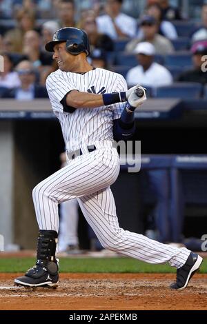 BRONX, NY - SEP 15: New York Yankees shortstop Derek Jeter hits an rbi single against the Tampa Bay Rays on September 15, 2012 at Yankee Stadium. Stock Photo