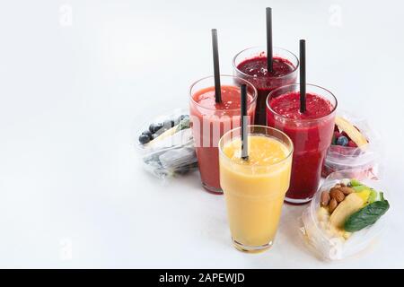 Htalthy fresh fruit and vegetable smoothies with assorted ingredients served in packs. Front view with copy space Stock Photo
