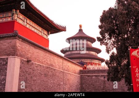 The hall of prayer for good harvests in the Temple of Heaven park in Beijing, China at sunset from behind walls. Typical Chinese architecture Stock Photo