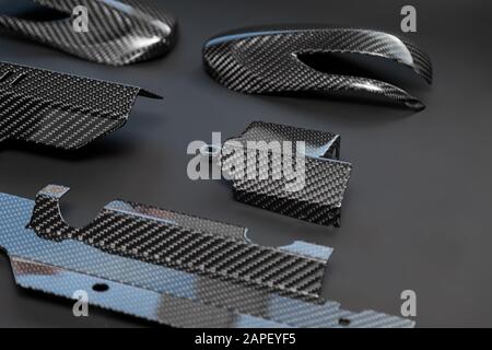 A close-up on a car exterior elements made from carbon fiber of interwoven black and gray color from heavy-duty yarns for the production of light and Stock Photo