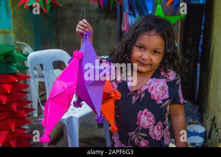 Filipino girl holding a lantern in a Christmas market in Las Pinas city , Manila the Philippines Stock Photo