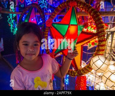 Filipino girl holding a lantern in a Christmas market in Las Pinas city , Manila the Philippines Stock Photo