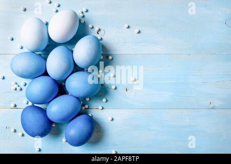 Easter concept. Ombre eggs in blue colors on blue wooden background with copy space for text. Top down view or flat lay. Classic blue colors in Easter 2020 Stock Photo
