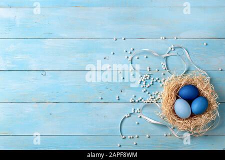 Easter concept. Ombre eggs in blue colors on blue wooden background with copy space for text. Top down view or flat lay. Classic blue colors in Easter 2020 Stock Photo