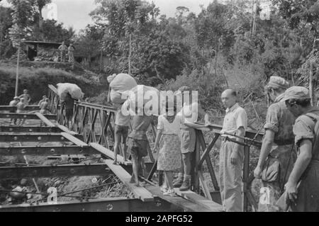 Bridge construction (Bailey) near kampong Ladjan, Suemowono Description: Bridge near Ladjan: The genius from Salatiga laid a Bailey bridge, since the old bridge is through the TNI. blown up. Hardly was the connection between the banks established or a Red Cross team goes across the bridge forward to perform its work among the population. Date: 23 November 1947 Location: Indonesia, Java, Dutch East Indies, Sumowono Stock Photo