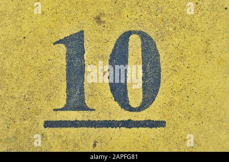 A house number plaque, showing the number ten (10) Stock Photo