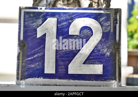 A house number plaque, showing the number twelve (12) Stock Photo