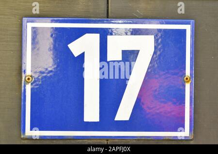 A house number plaque, showing the number seventeen (17) Stock Photo