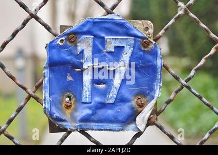 A house number plaque, showing the number seventeen (17) Stock Photo