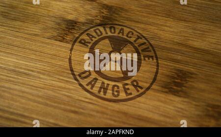 Radioactive danger symbol stamp printed on wooden box. Atomic energy warning, radiation alert and nuclear power hazard concept. Stock Photo