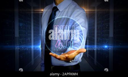 Man with industry 4.0 symbol hologram on hand. Businessman and futuristic concept of innovation, cyber technology, ai, business, digital tech and auto Stock Photo