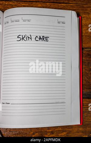 Skin care, handwriting text on page of office agenda. Copy space. Stock Photo