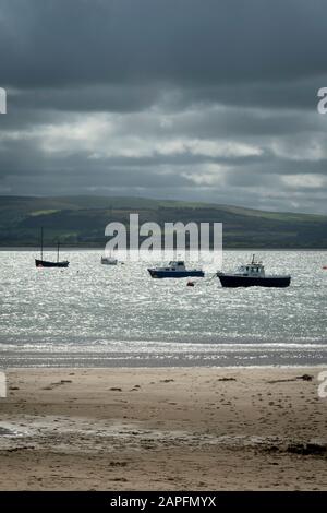 Boats moored in harbour under dark clouds, Aberdovey, Aberdyfi, Wales Stock Photo