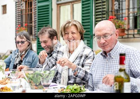 Senior couples at outdoor family lunch, Florence, Italy Stock Photo