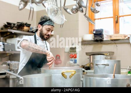 Chef cooking in kitchen Stock Photo