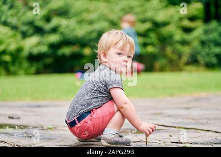 Toddlers exploring park Stock Photo