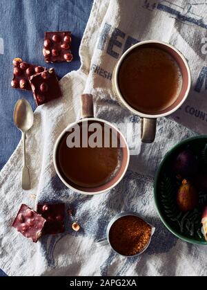 Hot chocolate drink, hazelnut chocolate and fruit pudding Stock Photo