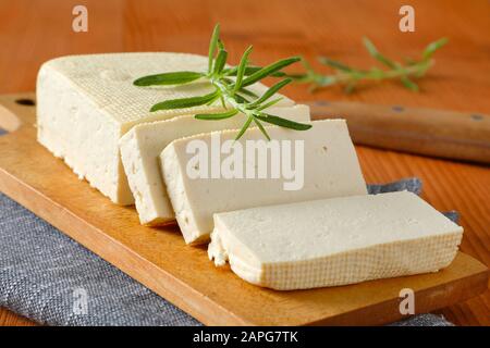 Sliced block of fresh bean curd (tofu) on cutting board Stock Photo