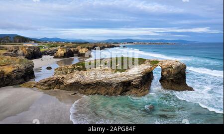 Aerial view of Natural stone arch on Playa de Las Catedrales (Beach of the Cathedrals), Galicia, Spain Stock Photo