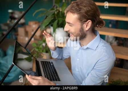 Man using his laptop while having a video call Stock Photo