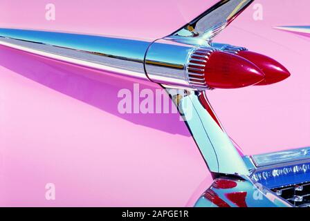 Closeup of red backlights of a pink shiny retro car under the lights Stock Photo